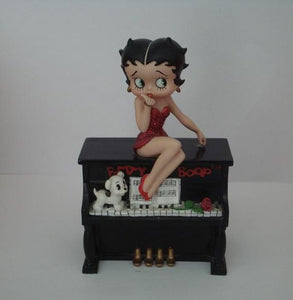 Betty Boop sitting on top of a piano blowing a kiss musical. (Retired and Rare)